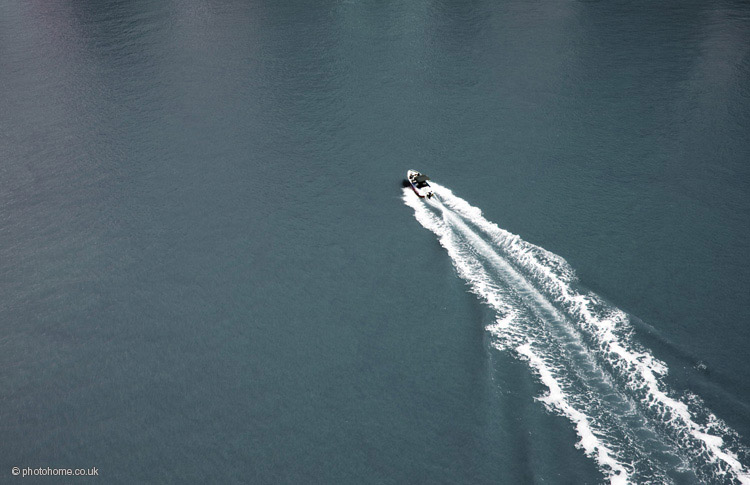 a motor boat and it's wake viewed from above