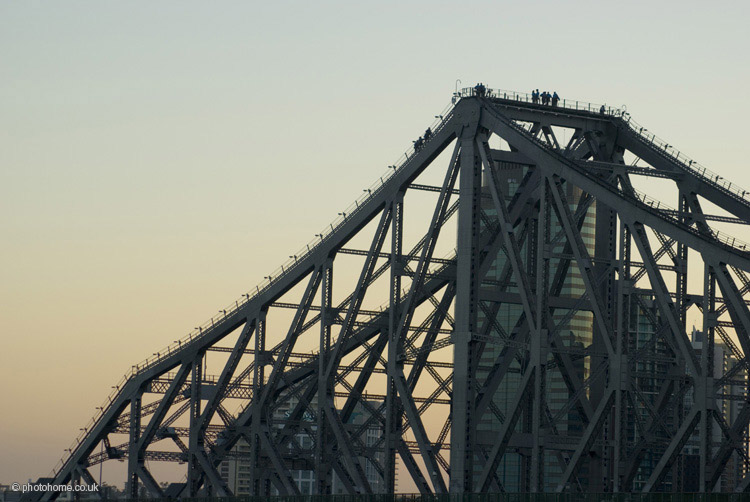 climbers on the story bridge at sunset